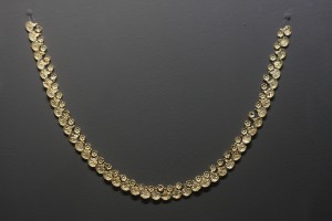 Golden necklace made of tesserae in the shape of rosettes and lily-papyrus flowers. From  the Mycenaean Tholos tomb at the site "Kazanaki" of Volos, 1500-1300 BC. The tomb was discovered in 2004, while building the ring road of Volos.